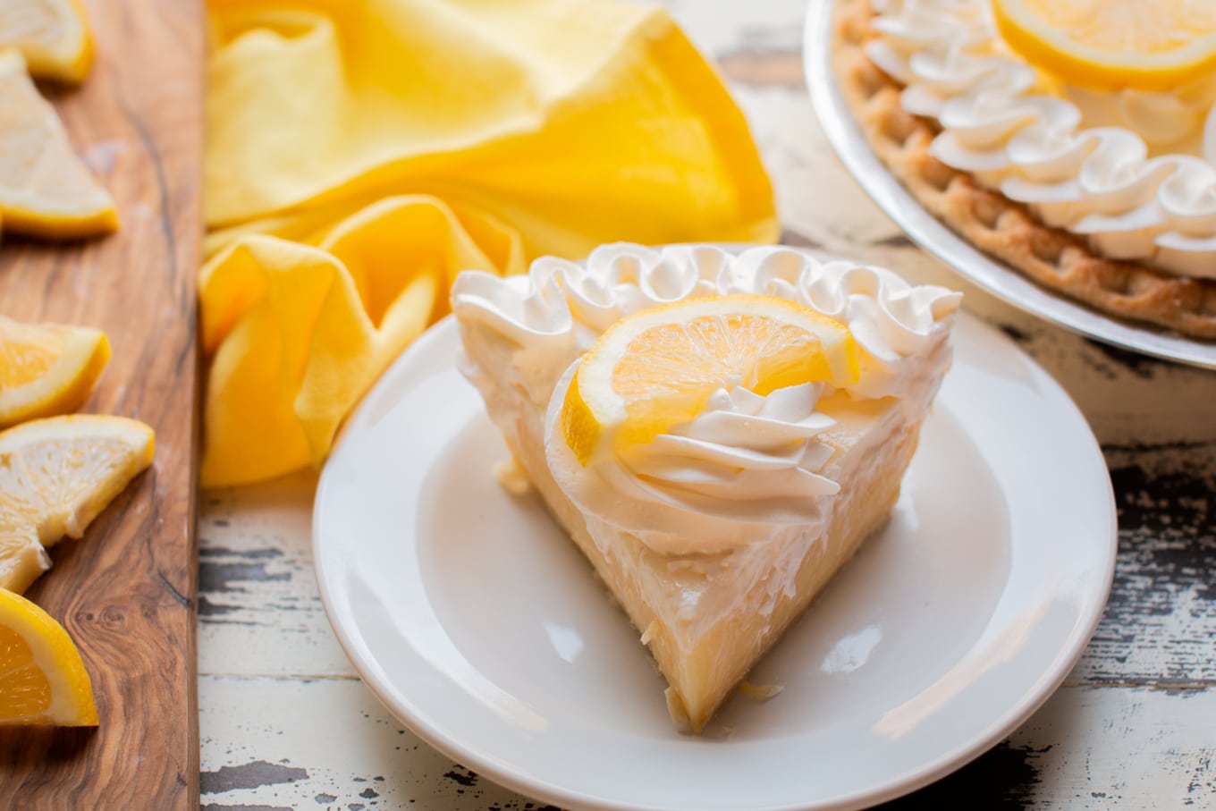 slice of sour cream leomon pie on white plate