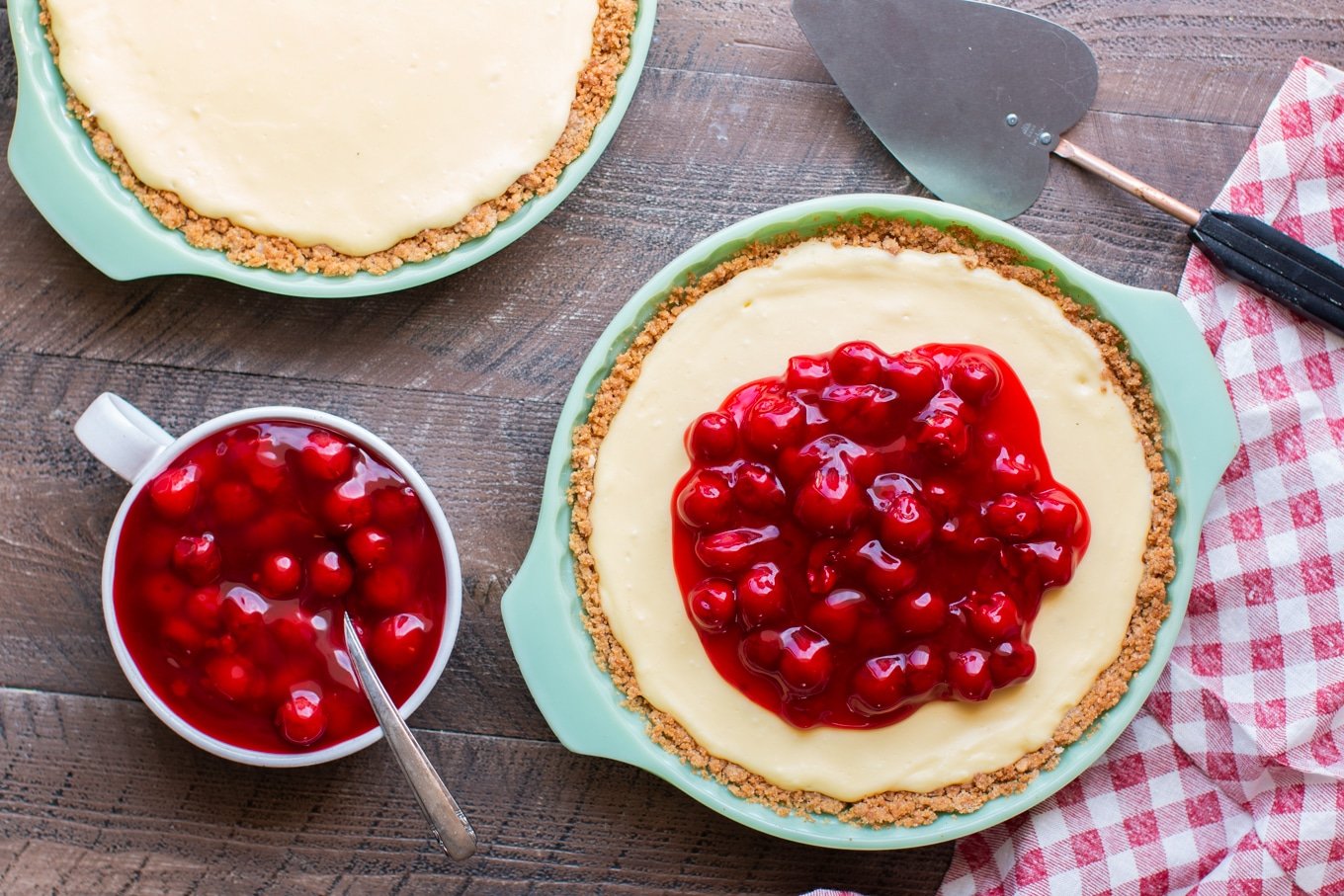 2 cream cheese pies on wooden table.