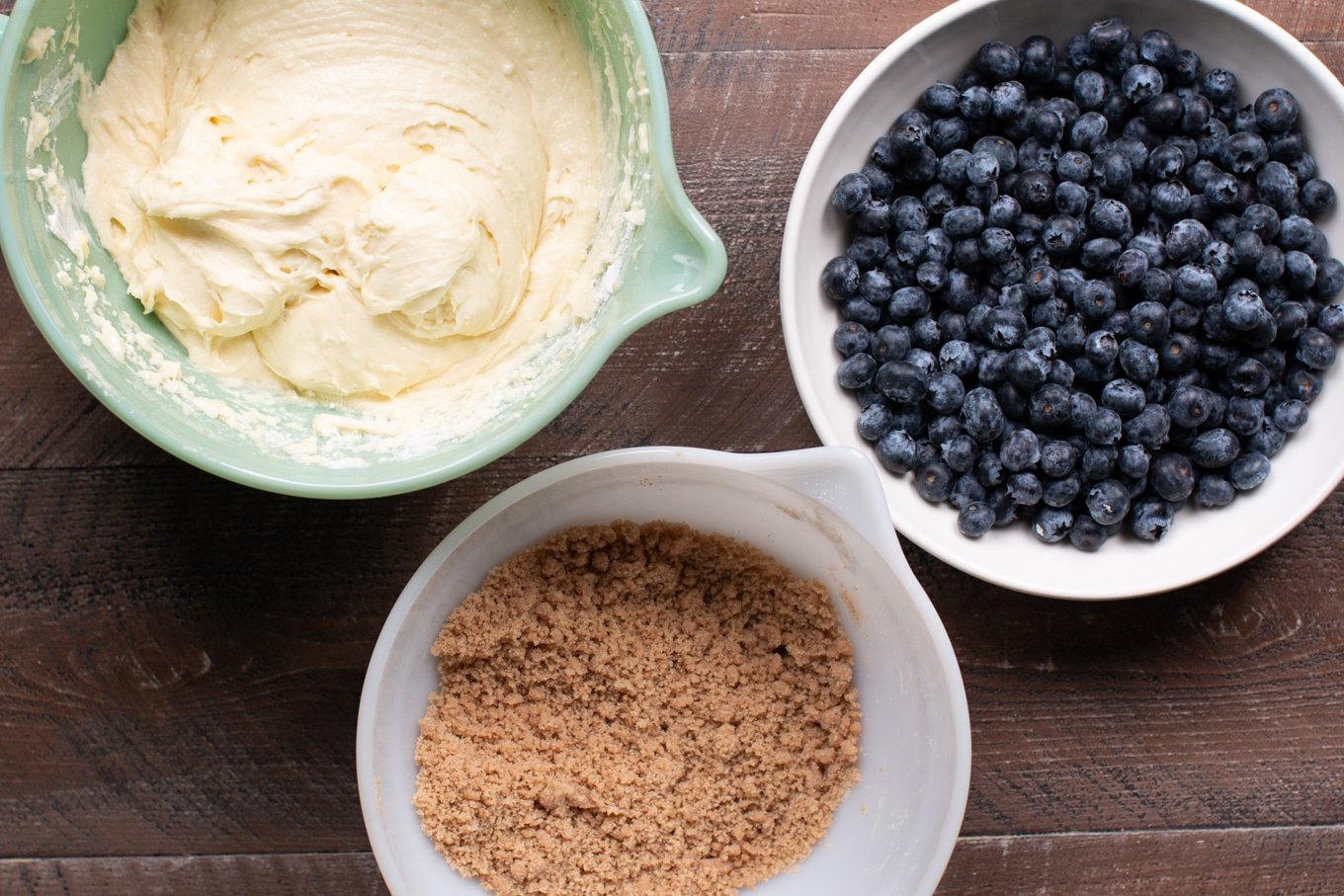 battter, blueberries and streusel in bowls