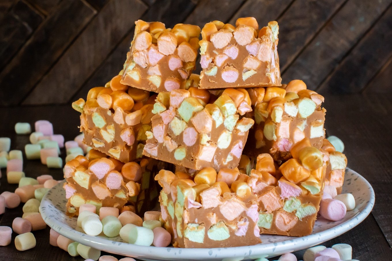 peanut butter squares with multi-colored marshmallows in them.