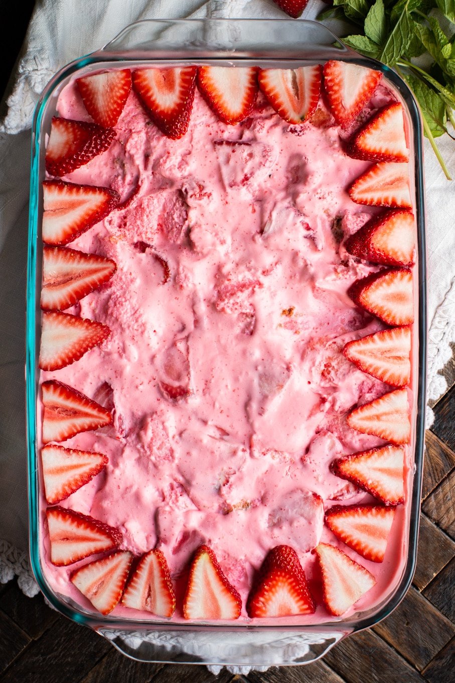 strawberry angel food dessert with fresh strawberries on top.