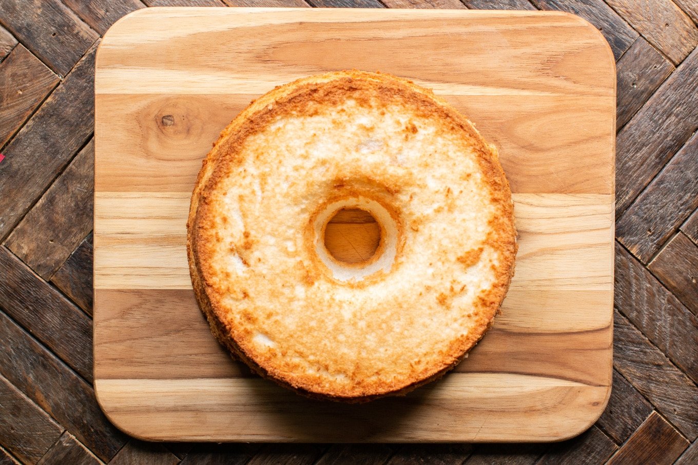 angel food cake round on cutting board.