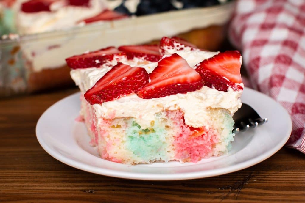 close up of jello poke cake on white plate