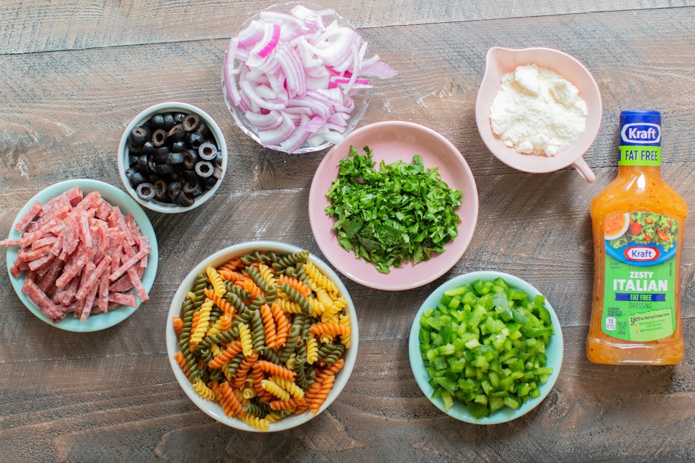 ingredients for pasta salad on a wooden cutting board