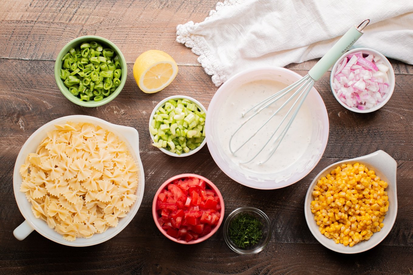 ingredients for pasta salad on wooden table.