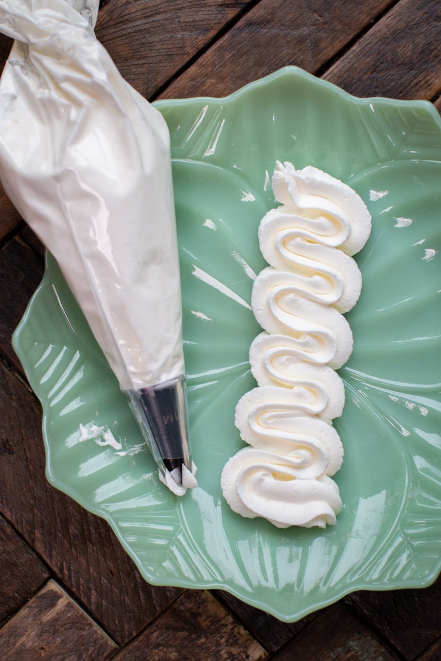 piped whipped cream on jadeite plate.