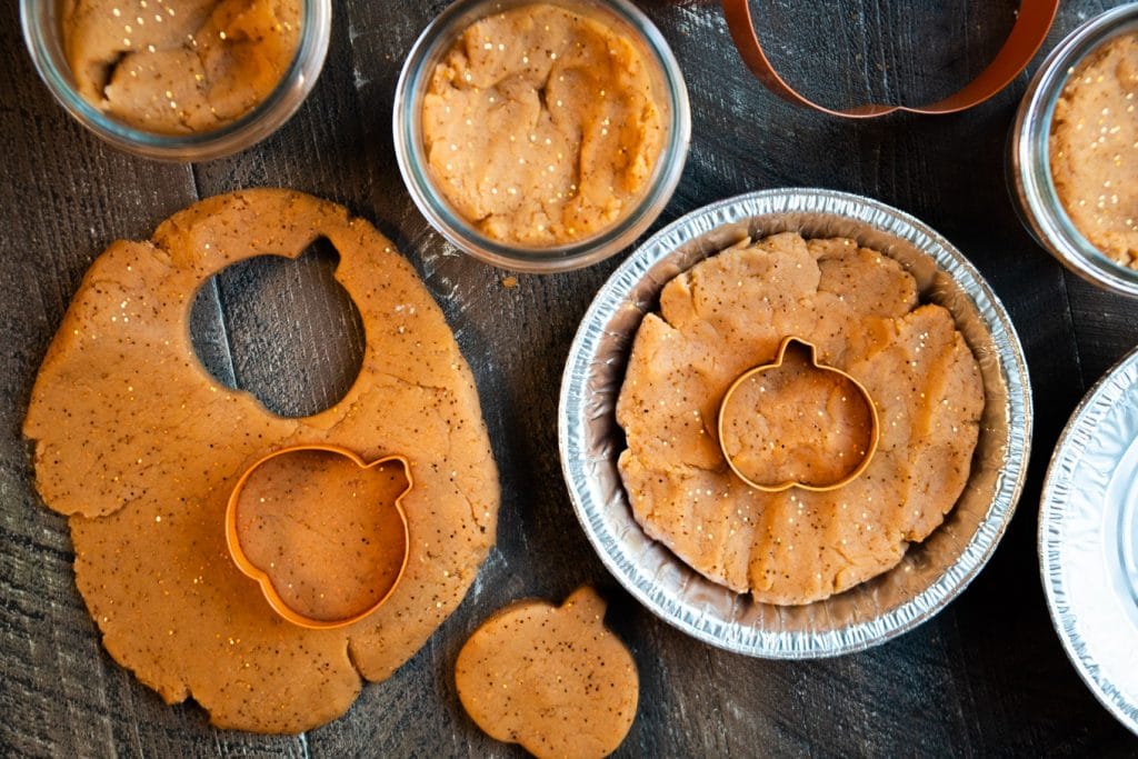 pumpkin dough with cookie cutters and mini pie tin.