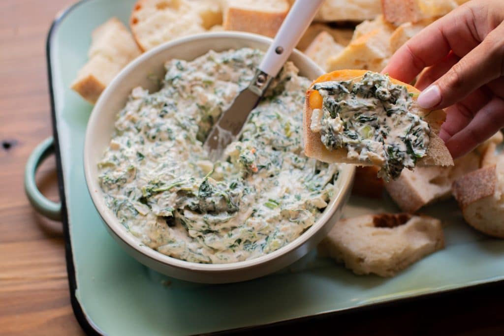 spinach dip on piece of bread.