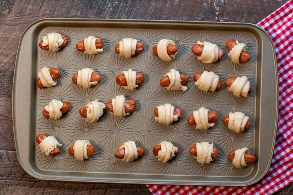 uncooked pigs in a blanket on a cookie sheet