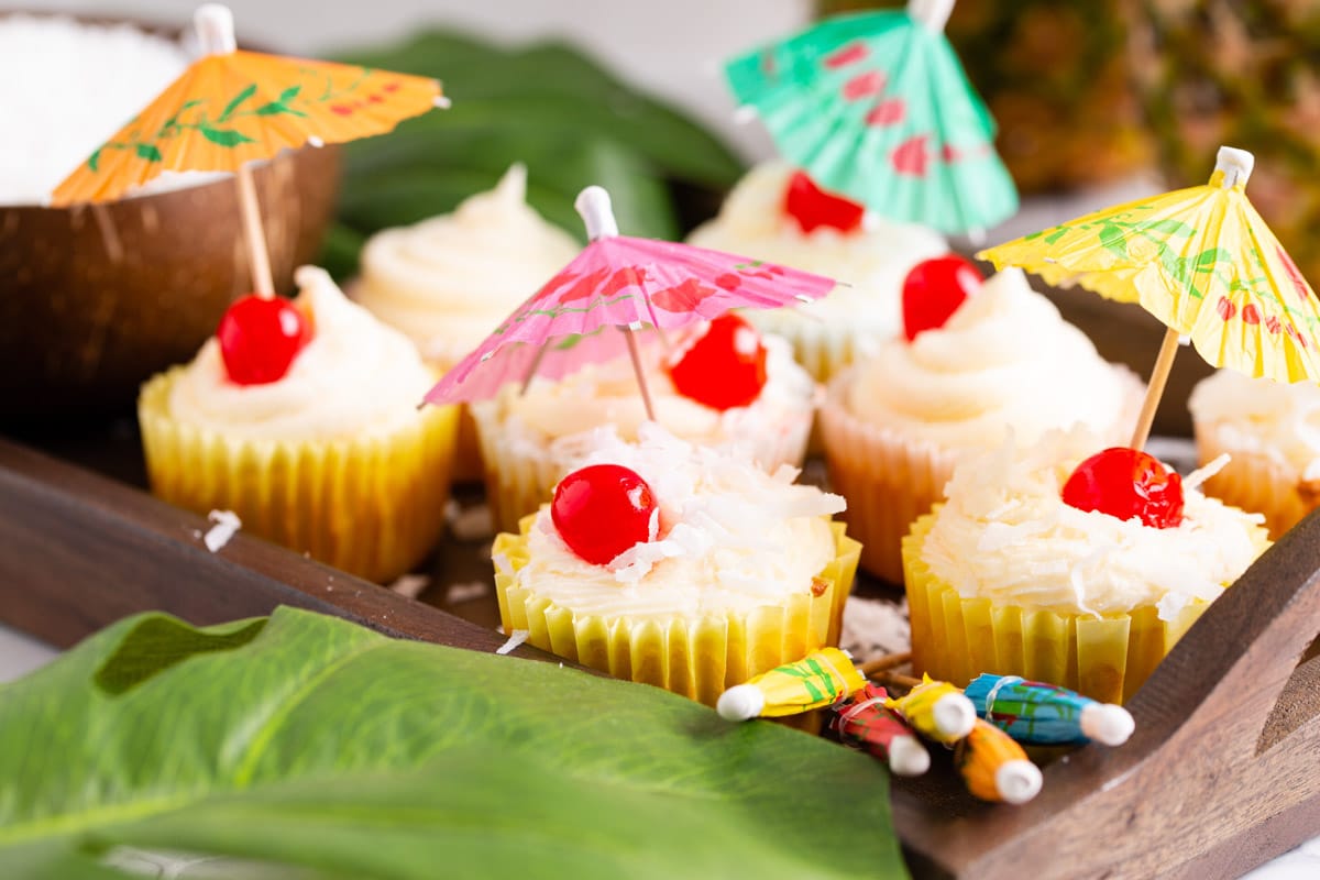 tray of beautifully decorated cupcakes on tray.