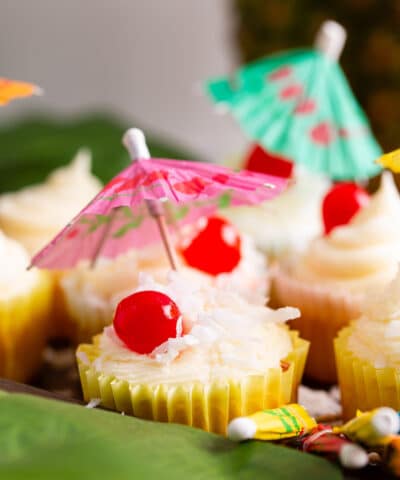 close up of pina colada cupcake with a pink umbrella
