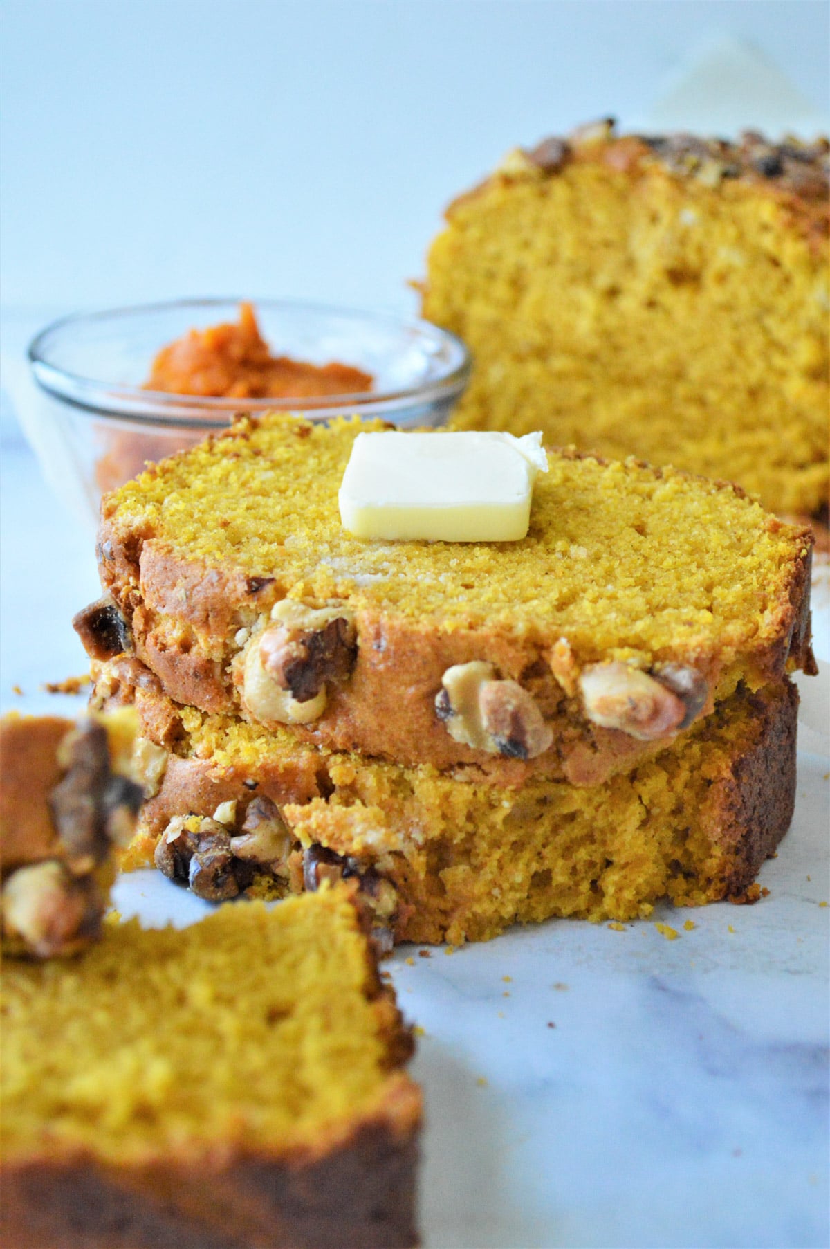 Slices of pumpkin bread with a pat of butter