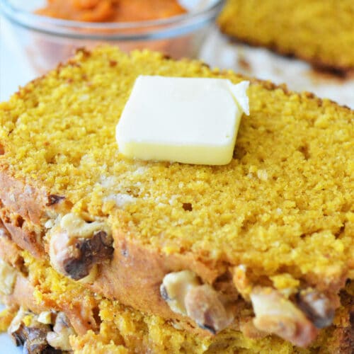 close up of pumpkin bread slices with butter