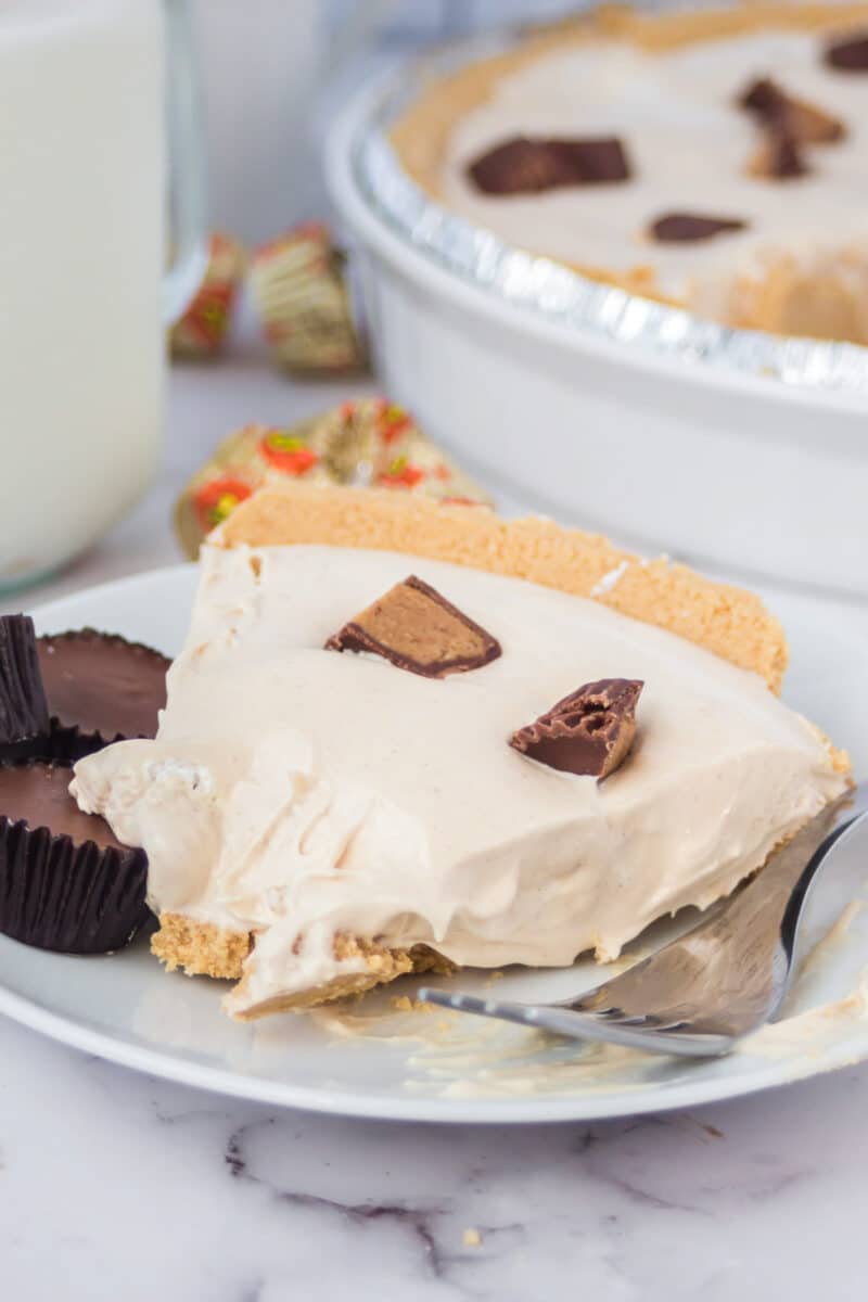 slice of peanut butter pie on a plate with a bite taken out.