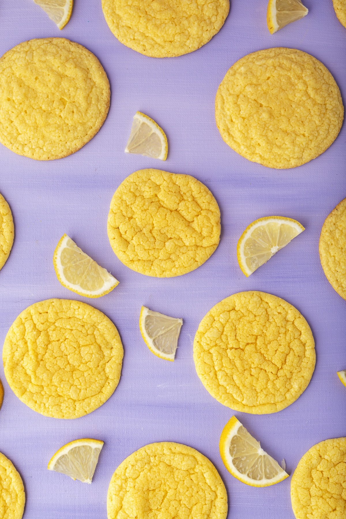 lemon cookies and lemon on purple table.