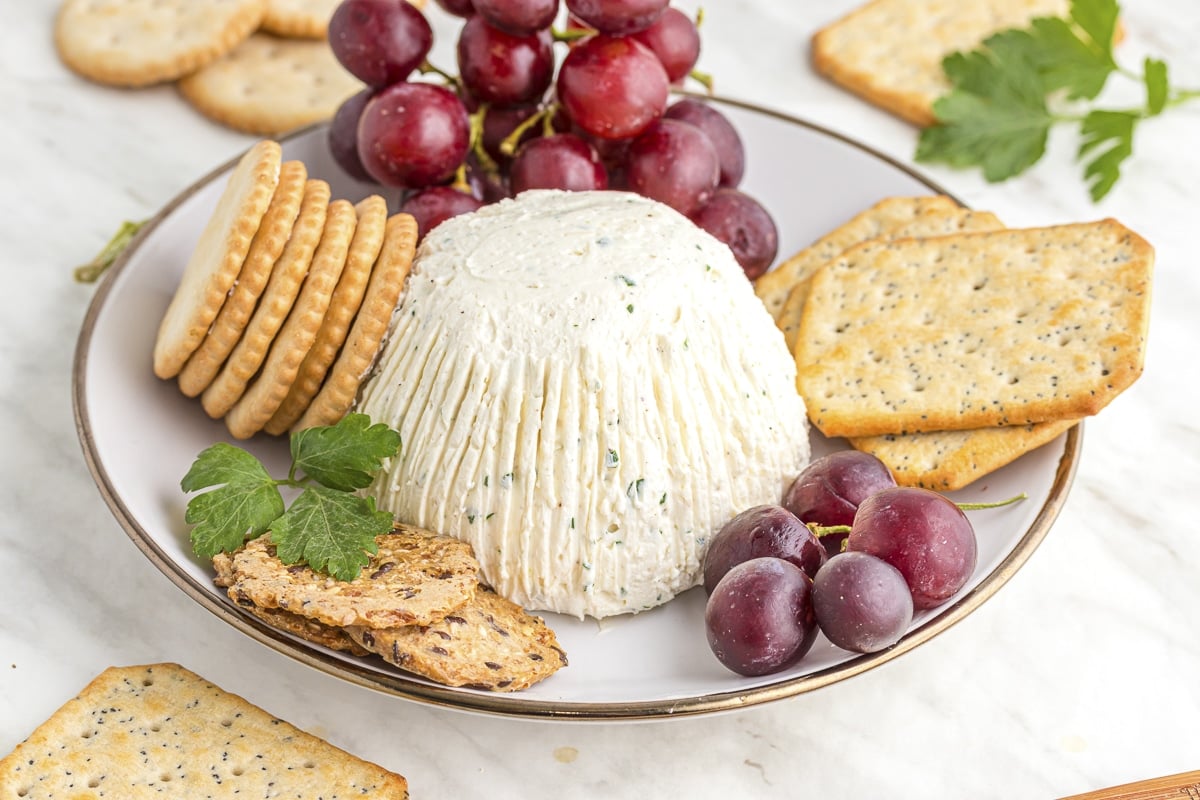 plate of homemade boursin cheese, crackers and grapes.