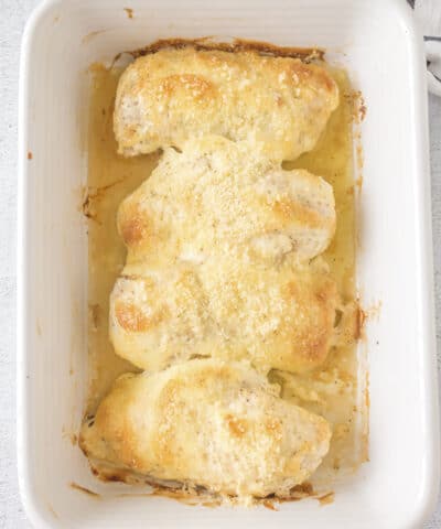 mayonnaise parmesan chicken baked in white casserole dish.