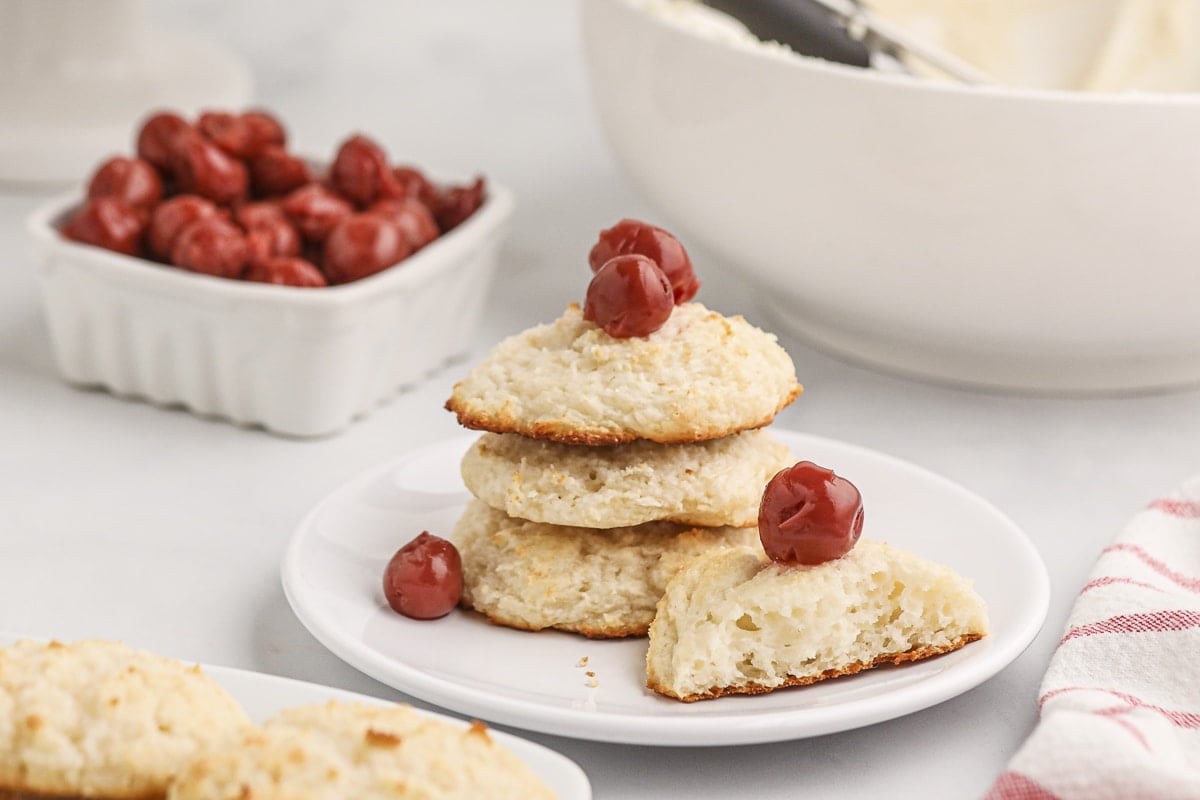 plate of angel food cake mix cookies with cherries on top.