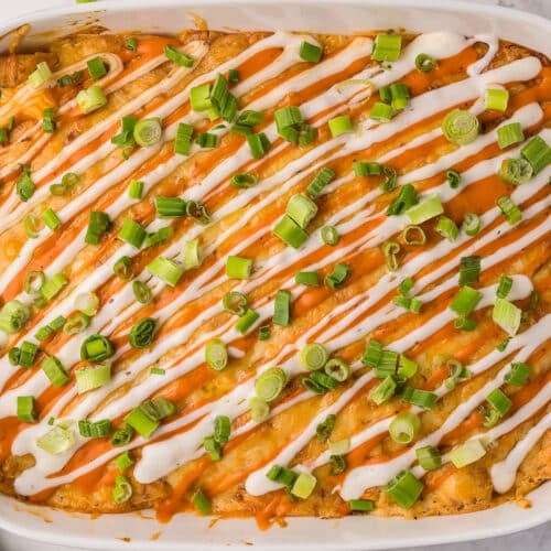 tray of buffalo enchiladas with green onion on top.