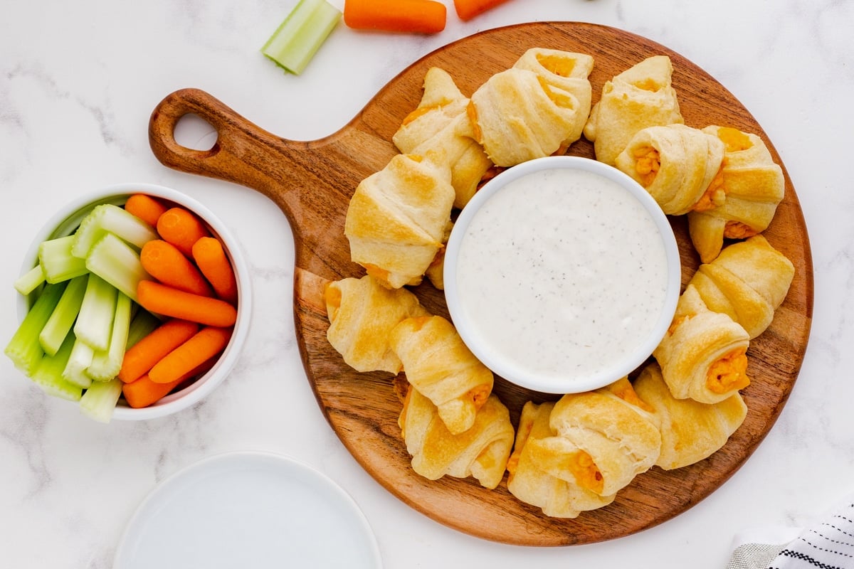 buffalo chicken crescents with ranch on a platter.