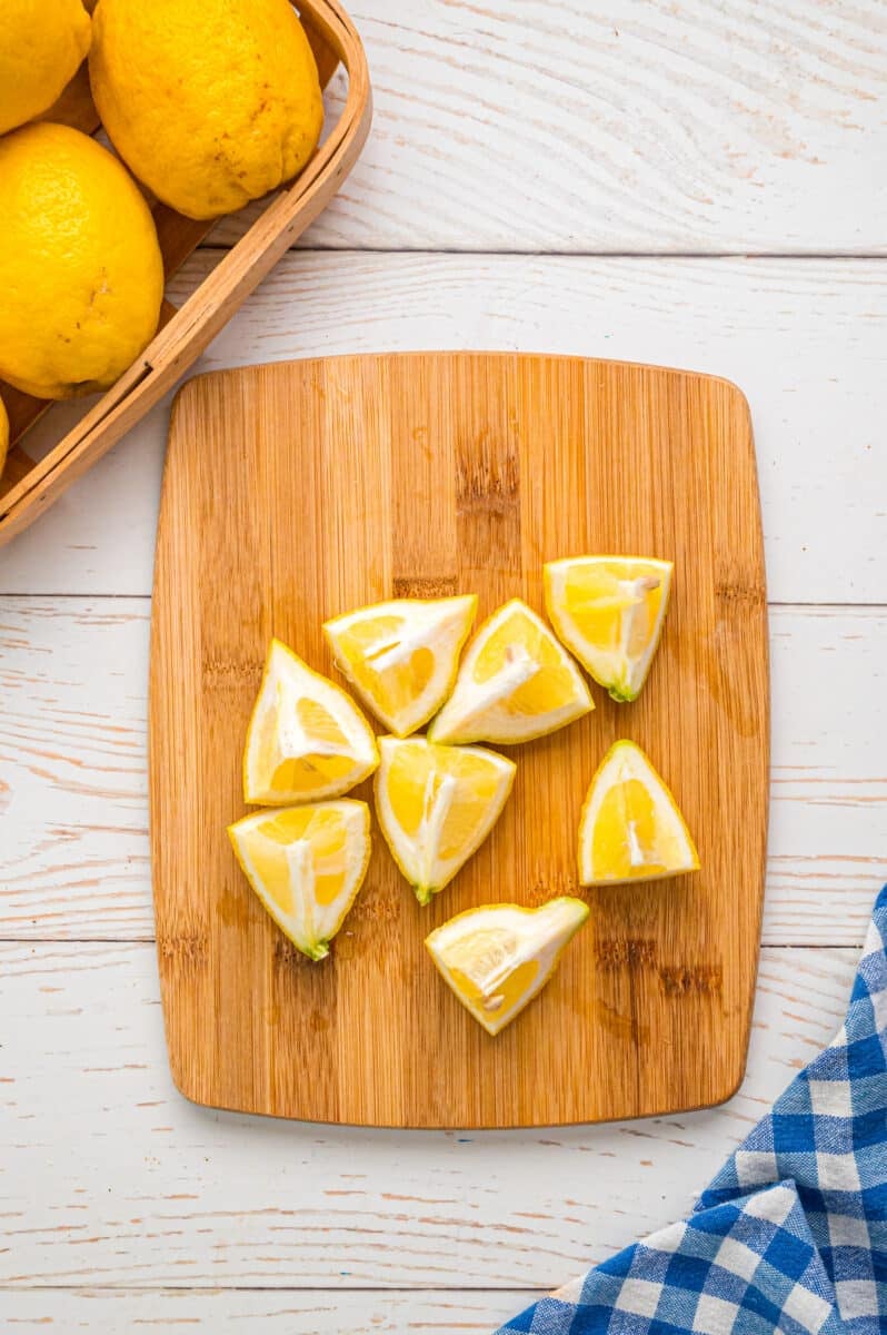 Cut lemons on a wooden board.